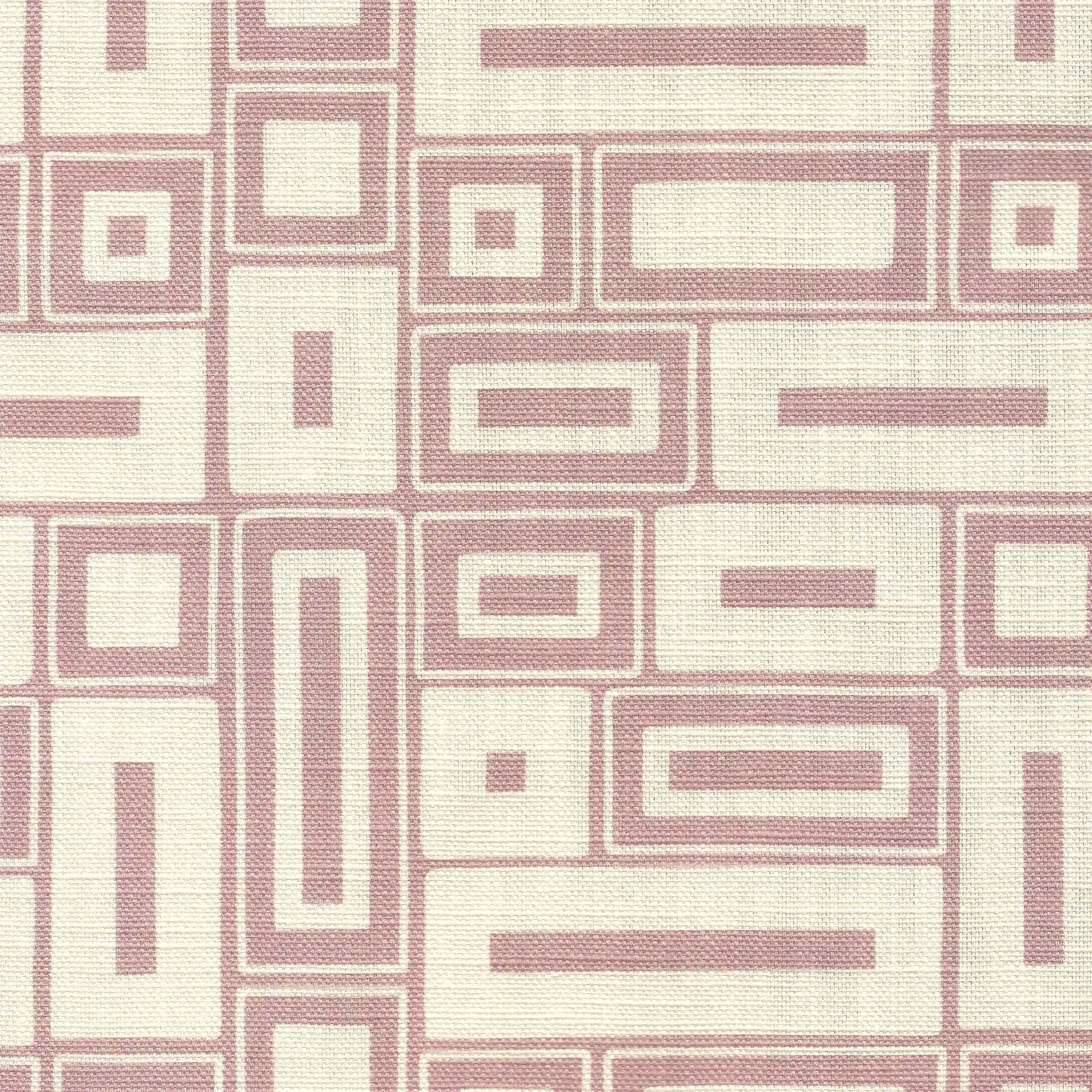 A close-up of a printedfabric with a repeating geometric pattern of pink rectangles and lines on a warm off-white background.