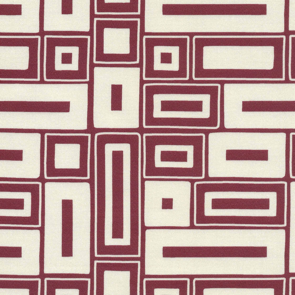 A close-up of a geometric patterned fabric featuring alternating cream and burgundy rectangular blocks outlined with thin intersecting lines.