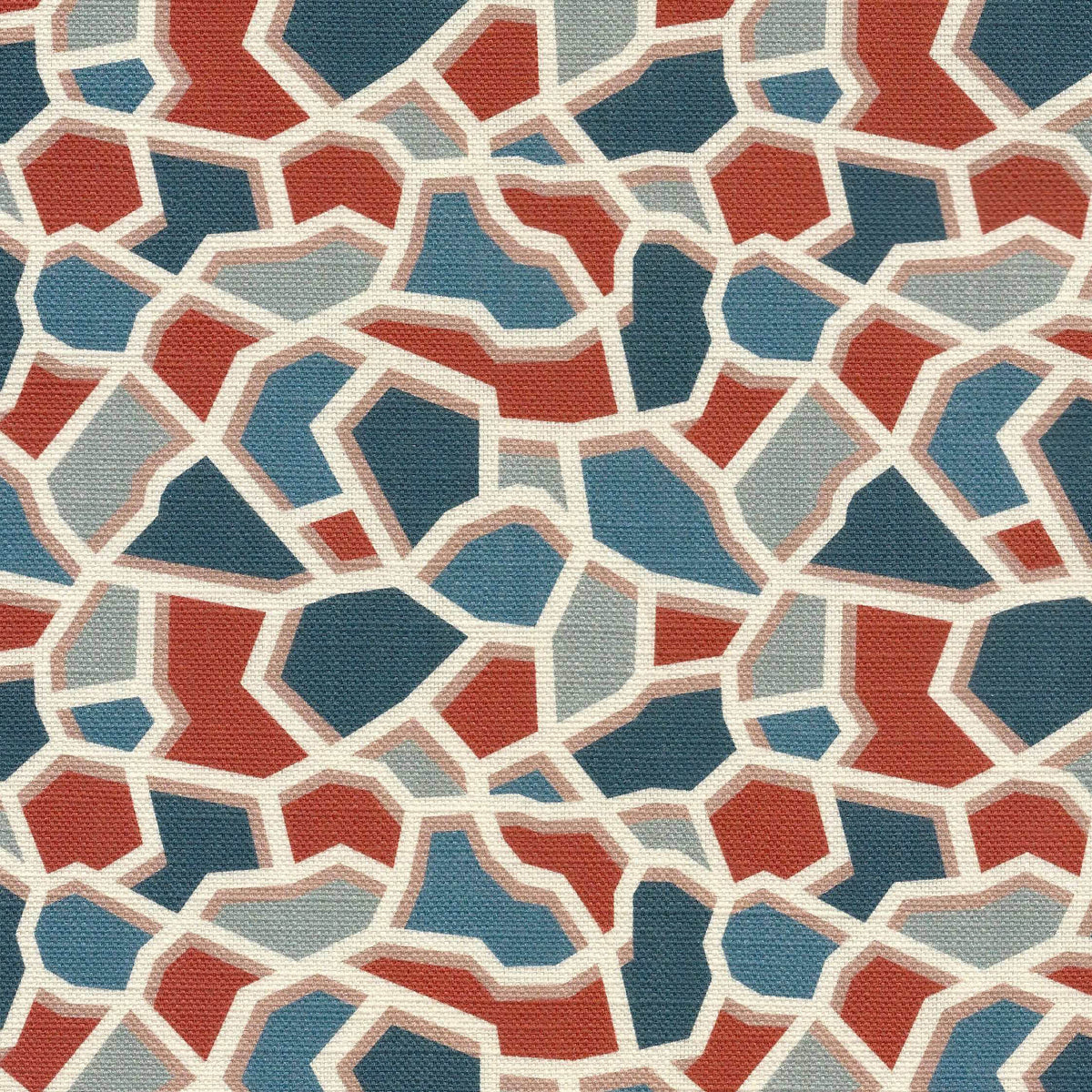 A close-up of a printed fabric with an abstract geometric pattern of irregular polygon shapes in terracotta, slate blue, light blue, and cream, separated by off-white lines.