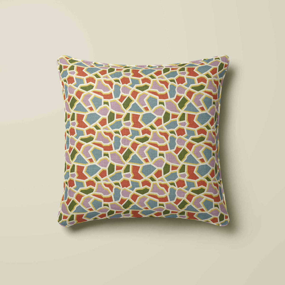 A square throw pillow featuring a colorful mosaic tile pattern in shades of blue, green, orange and pink set outlined in a yellow and light beige background.